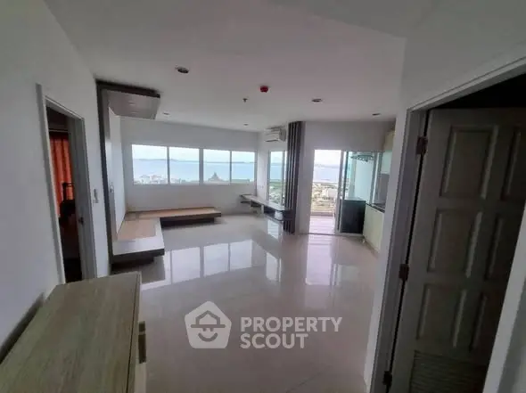 Spacious living room with panoramic windows and stunning city view.