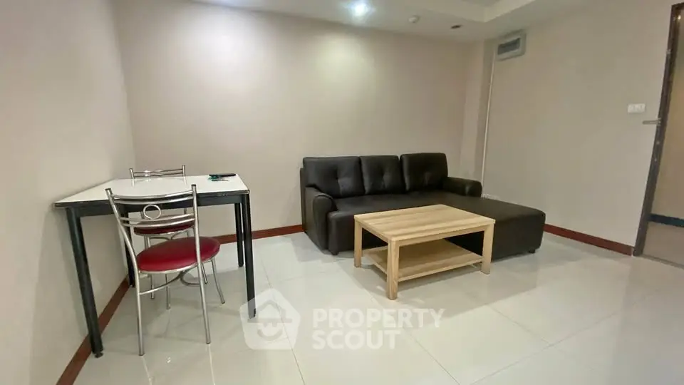 Cozy living room with modern sofa and dining table in a minimalist apartment.