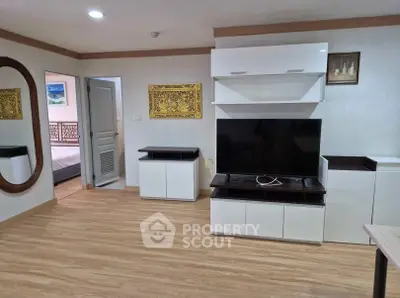 Modern living room with sleek TV unit and wooden flooring