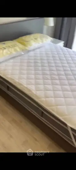 Modern bedroom with stylish bed and cozy ambiance in a contemporary apartment.