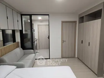 Modern studio apartment with sleek furniture and built-in storage