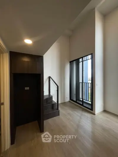 Spacious modern living room with high ceilings and large windows