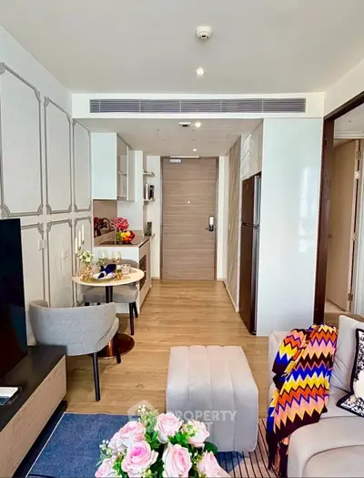 Modern living room with stylish decor and open kitchen layout in a cozy apartment.