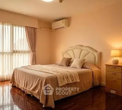 Spacious bedroom with elegant decor and natural light in modern apartment.