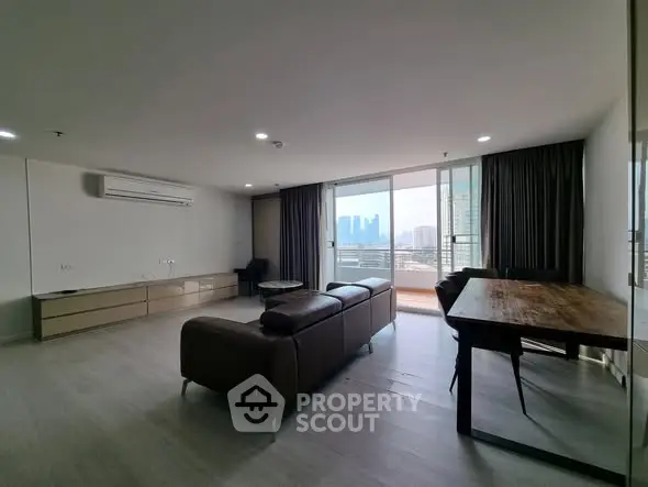 Spacious modern living room with city view and balcony access