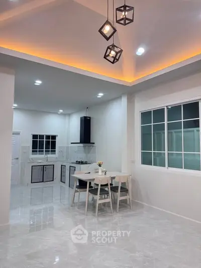 Modern kitchen with open layout and stylish lighting in a contemporary home.