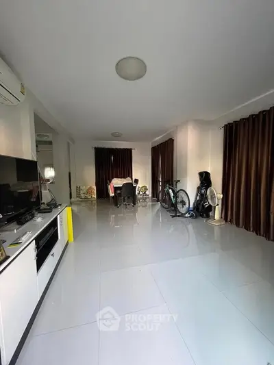 Spacious living room with modern decor and ample natural light, perfect for family gatherings.