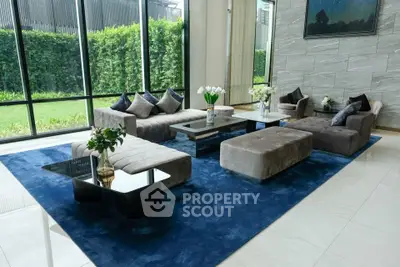 Luxurious modern living room with plush sofas and garden view