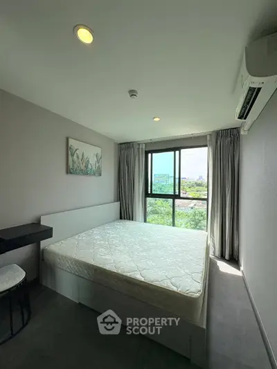 Modern bedroom with large window and scenic view, featuring a comfortable bed and stylish decor.