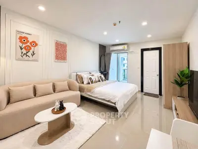 Spacious modern bedroom with cozy seating area and stylish decor