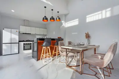 Modern kitchen and dining area with sleek design and natural light
