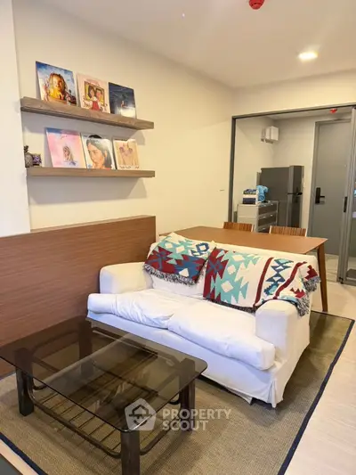 Cozy living room with modern decor and stylish shelving in a contemporary apartment.