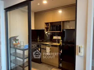 Modern compact kitchen with sleek cabinets and appliances