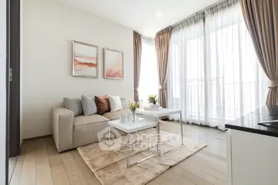 Modern living room with elegant decor and natural light, featuring a cozy sofa and stylish coffee table.