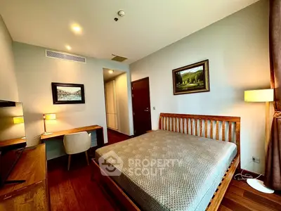 Spacious bedroom with wooden furniture and elegant decor in modern apartment