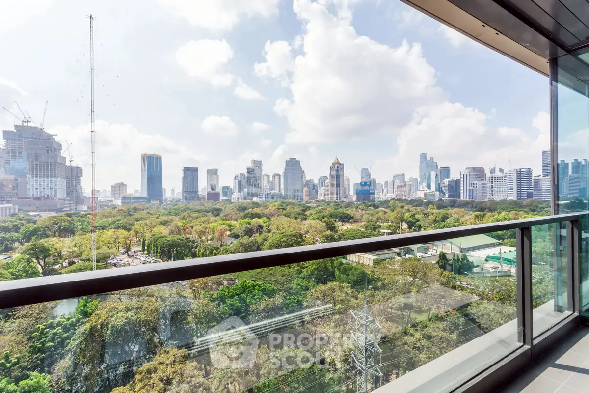 Stunning cityscape view from a modern balcony overlooking lush greenery and skyline.