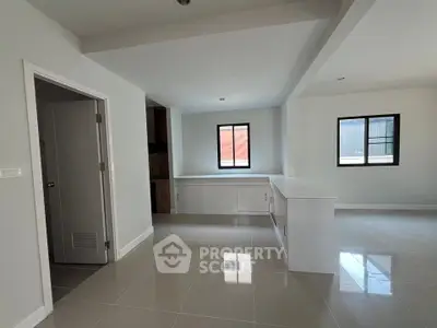Spacious modern living area with sleek tile flooring and ample natural light