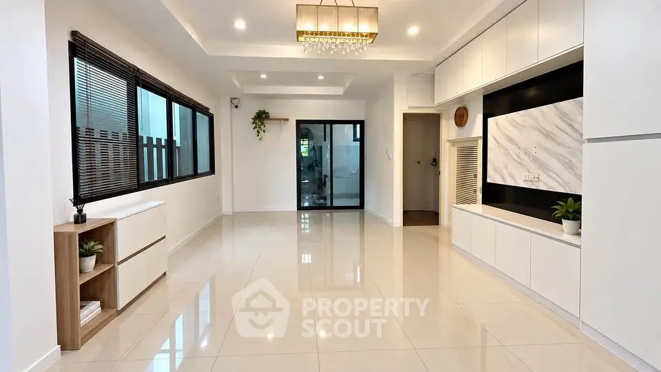 Spacious modern living room with elegant lighting and sleek built-in storage.