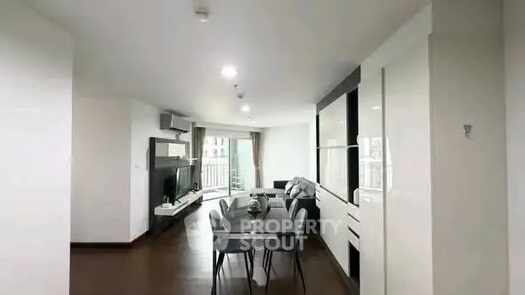 Spacious modern living room with dining area and sleek furnishings in a contemporary apartment.