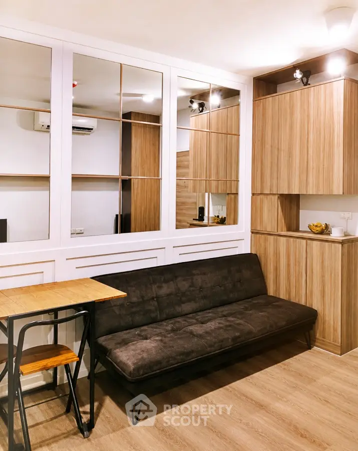 Modern living room with stylish wooden cabinetry and cozy sofa in a contemporary apartment.