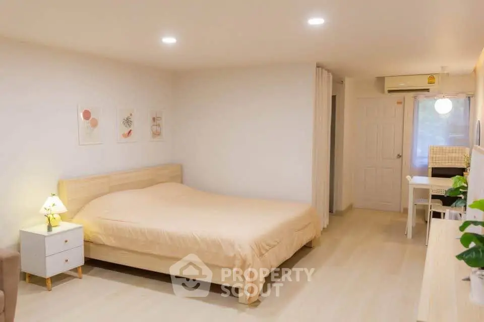 Spacious bedroom with modern decor and cozy ambiance, featuring a comfortable bed and stylish furnishings.