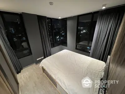 Modern bedroom with city view and floor-to-ceiling windows