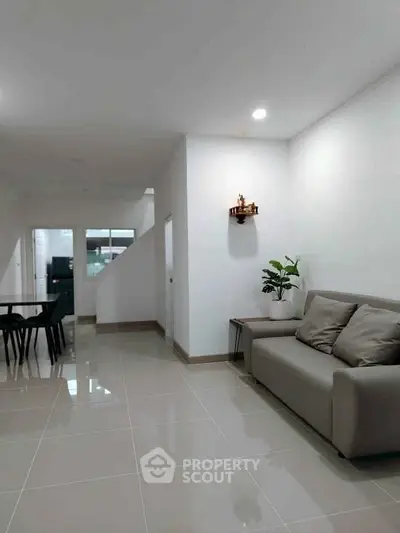 Spacious modern living room with sleek tile flooring and minimalist decor