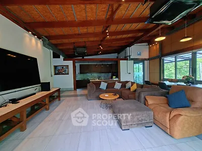 Spacious living room with modern decor and large windows offering natural light.