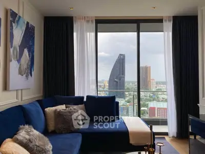Luxurious living room with stunning city view from high-rise apartment, featuring elegant blue sofa and modern decor.