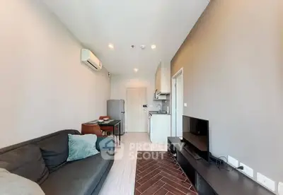 Modern living room with sleek furniture and open kitchen layout