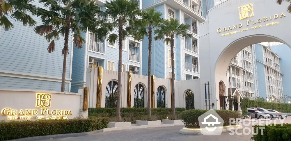 Luxurious Grand Florida condominium entrance with palm trees and elegant architecture