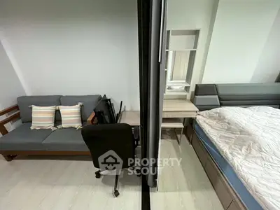 Modern studio apartment with cozy living area and comfortable bed, perfect for urban living.