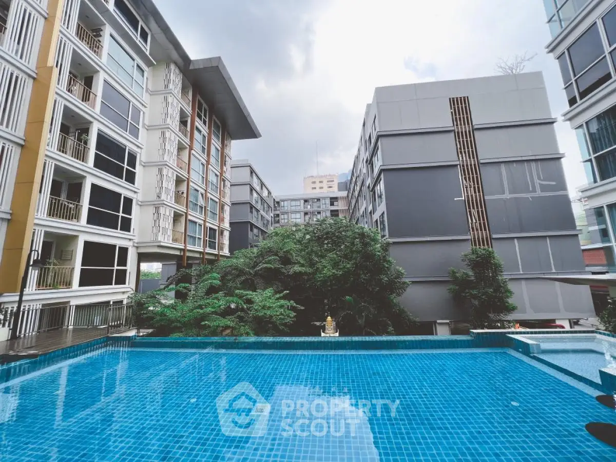 Modern apartment complex with a stunning pool view and lush greenery