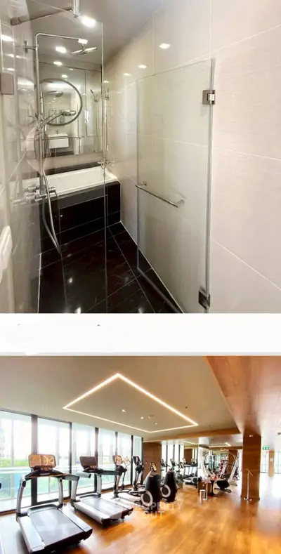 Luxurious bathroom with glass shower and modern gym with panoramic windows.