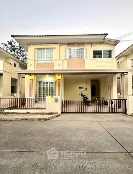 Charming two-story house with modern facade and spacious driveway in a serene neighborhood.
