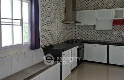 Modern kitchen with patterned tiles and sleek cabinetry