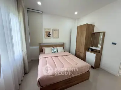 Cozy modern bedroom with stylish wooden furniture and soft pink bedding