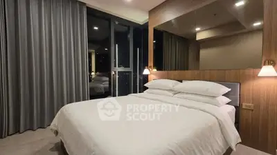 Luxurious modern bedroom with floor-to-ceiling windows and elegant lighting.
