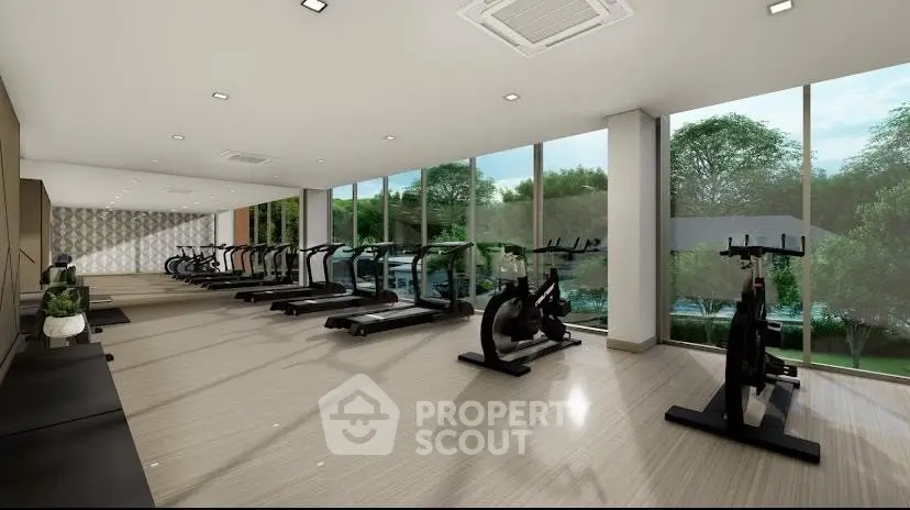 Modern gym with large windows and state-of-the-art equipment in luxury residential building.