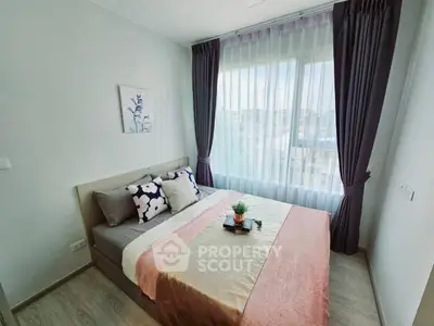 Cozy bedroom with large window and stylish decor in modern apartment