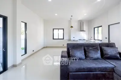 Spacious modern living room with open kitchen and sleek design