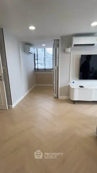 Modern living room with sleek flooring and air conditioning