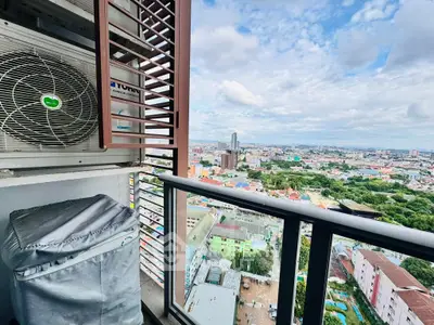 Stunning cityscape view from high-rise balcony with air conditioning unit.