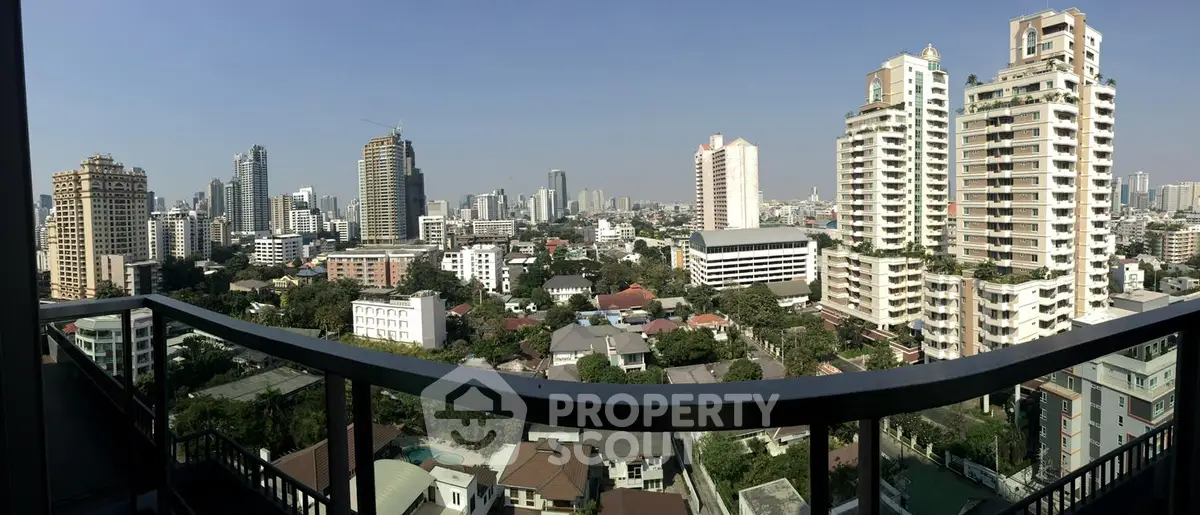 Stunning panoramic cityscape view from a high-rise balcony showcasing urban skyline and modern architecture.