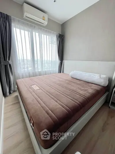 Modern bedroom with large window and air conditioning, featuring elegant curtains and a comfortable bed.