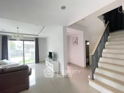 Spacious living room with modern decor and staircase in a bright home