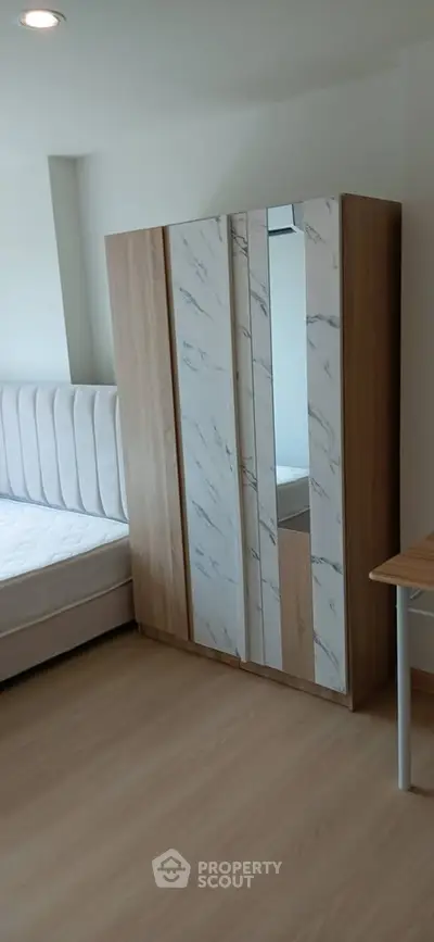 Modern bedroom with stylish wardrobe and comfortable bed in a cozy apartment.