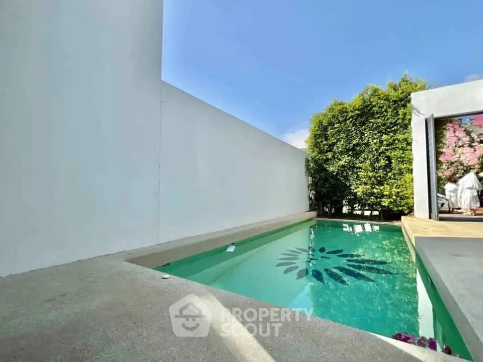 Luxurious private pool with modern design and lush greenery, perfect for relaxation and entertainment.