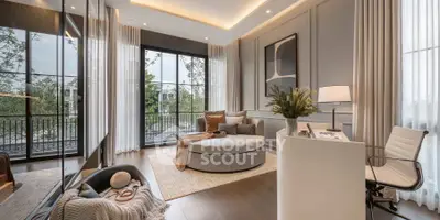 Luxurious modern living room with elegant decor and large windows opening to a scenic balcony view.