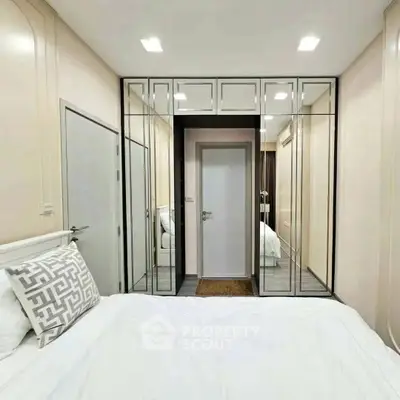 Modern bedroom with mirrored closet doors and stylish decor